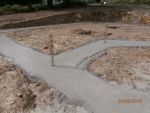 Coulage des fouilles avec du béton dosé à 350 kg et chainage 8x8 tor de 10 en attente